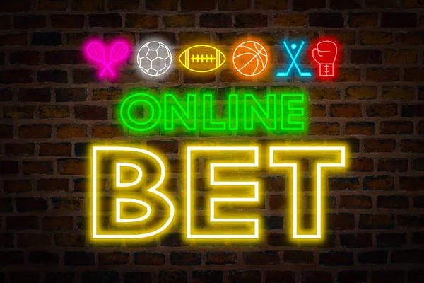 Neon signboard online bet, sports symbols, Football, American football, Basketball, Tenis, Boxing, Hockey against the backdrop of a brick wall. Concept bookmaker betting on sports online.
