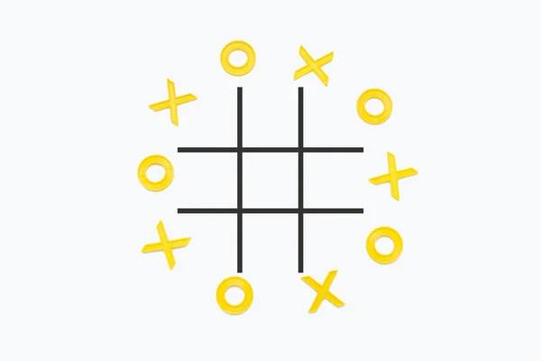 Yellow plastic figures for playing tic-tac-toe nails lined up on a white background. Flat lay, top view.