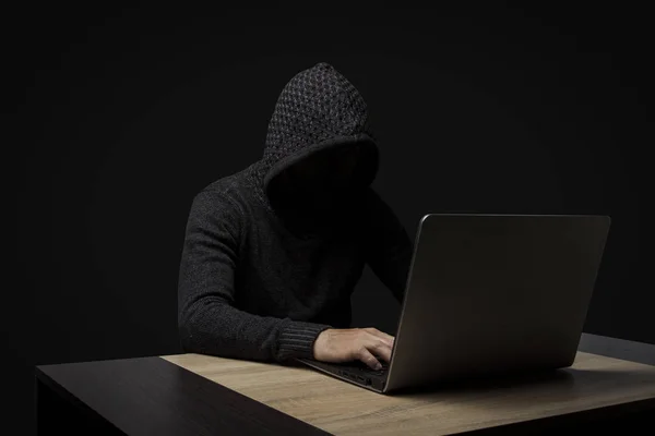 Faceless Man Hooded Robe Sits Table Laptop Dark Background Concept — Stock Photo, Image