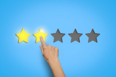 El a beğenilme-in iki yıldız beş mümkün dışarı mavi bir arka plan üzerinde bırakır. Bir şey değerlendirme kavramı.