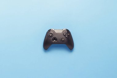 Mavi bir arka plan üzerinde gamepad. Konsol veya bilgisayar oyun kavramı. İşten sonra bekletin. Cybersport. Düz yatıyordu, en iyi görünümü.