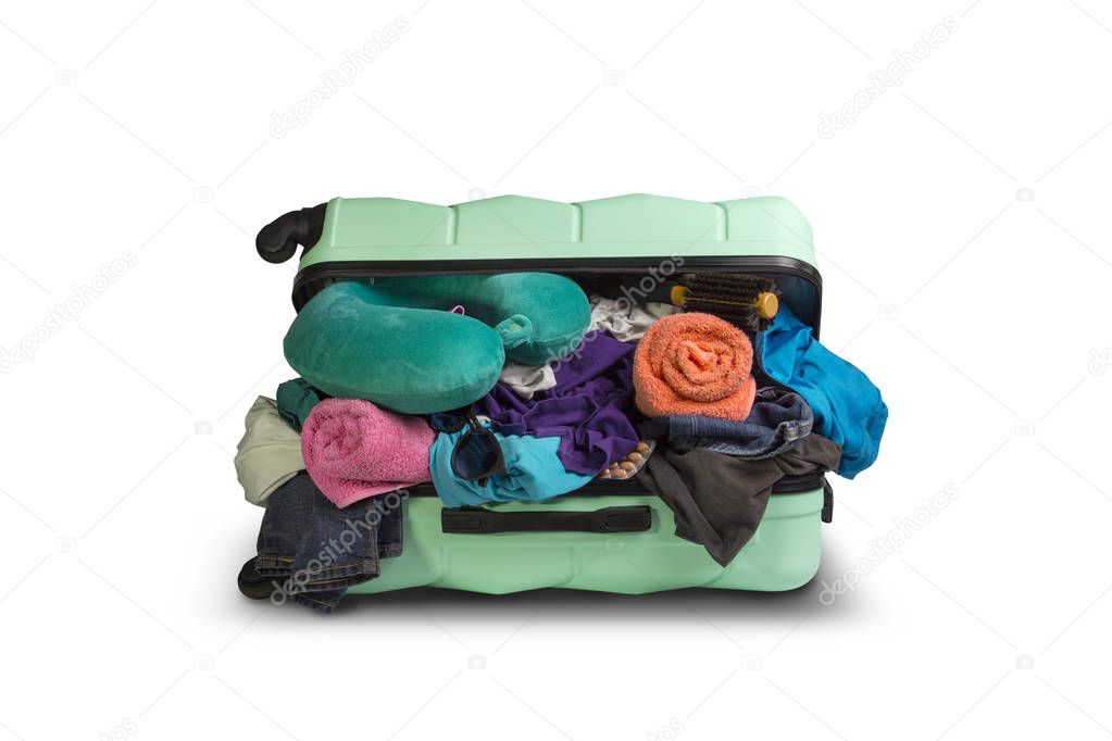 Plastic suitcase with wheels, overflowing things on a white background. Travel concept, vacation trip, visit to relatives.