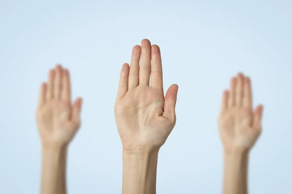 stock image Female palms raised up on a blue background. Stop gesture. Concept stop someone, warn.