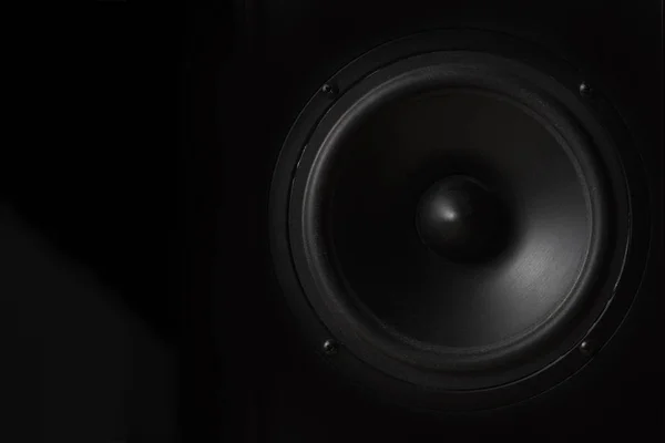 Black Music speaker on a black isolated background. Party or music listening concept