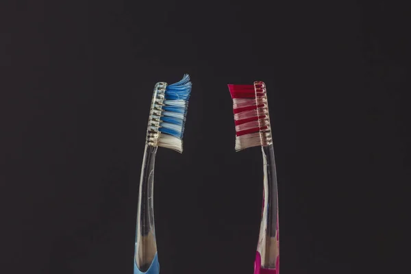 Used New Toothbrushes Look Each Other Black Background Concept Changing — Stock Photo, Image