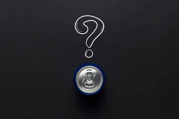 Tin can with a drink on a black background with a question mark. minimalism. Concept of an unknown drink, try the first time Flat lay, top view