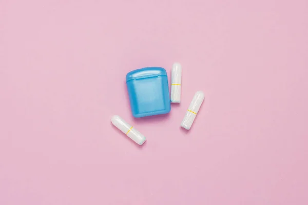 Feminine hygiene tampons and box for shipping and storage on a pink background. Concept of feminine hygiene during menstruation, critical days. Flat lay, top view