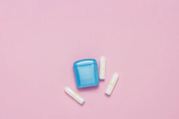 Feminine hygiene tampons and box for shipping and storage on a pink background. Concept of feminine hygiene during menstruation, critical days. Flat lay, top view