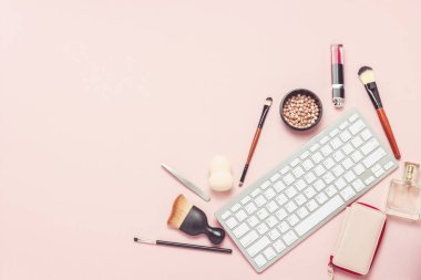 Makyaj ve güzellik araçları, pembe bir arka plan üzerinde klavye. Çevrimiçi eğitim, online mağaza, makyaj kozmetik sipariş, test kavramı. Düz yatıyordu, en iyi görünümü