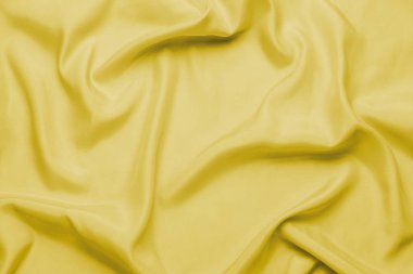 İpek kumaş veya statinler sarı dalgalar ile pürüzsüz, arka plan veya duvar kağıdı olarak kullanılabilir.