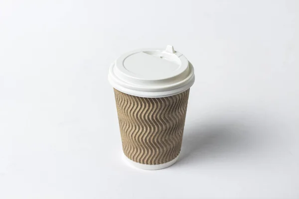 Paper cup with a protective lid on a white background. Concept coffee or tea to go, fast food, morning coffee, breakfast