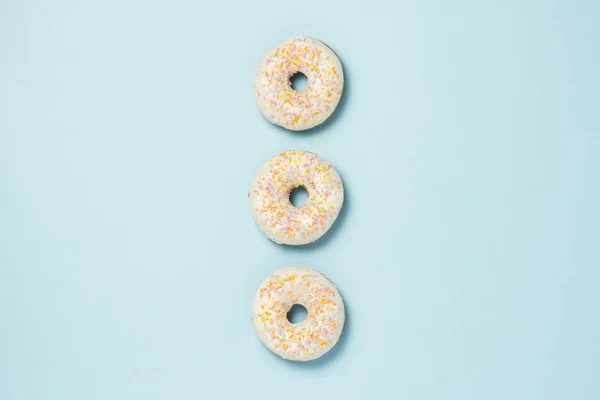 Три Свежих Сладких Пончика Выложенных Ряд Синем Фоне Концепция Быстрого — стоковое фото