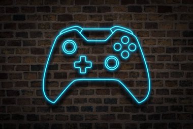 Oyun çubuğu veya Gamepad, Neon işareti bir tuğla duvar arka planda. Bilgisayar oyunları kavramı, turnuva