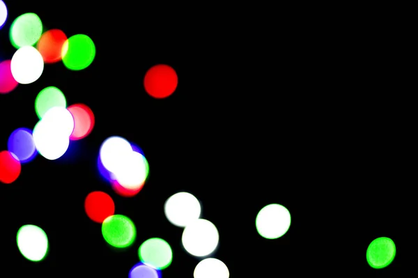 Multicolored bokeh on black background. Can be used as a background or wallpaper
