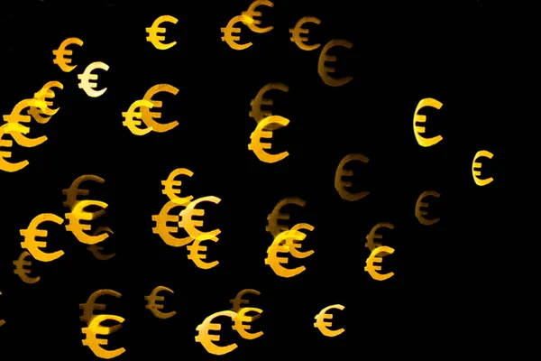 Bokeh as a Euro sign. The concept of wealth and money, trading on the stock exchange and economic growth, rich