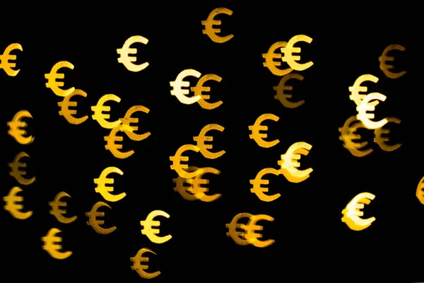 Bokeh as a Euro sign. The concept of wealth and money, trading on the stock exchange and economic growth, rich