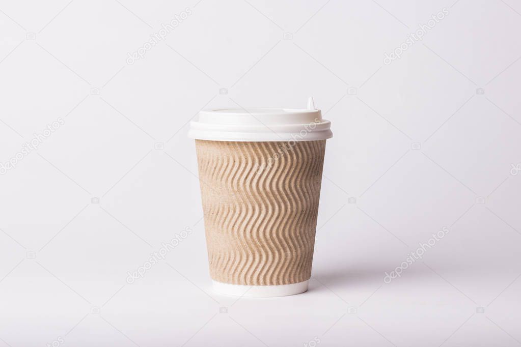 Paper cup with plastic lid on a white background. Hot drink concept, tea or coffee, takeaway
