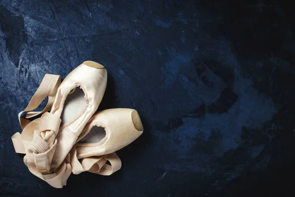 Ballerina shoes, Pointe shoes without people. On a dark backgrou