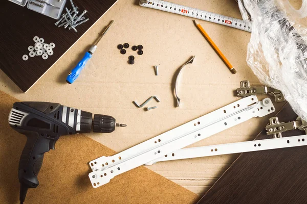 Tools, Furniture parts, Wrapping film, Screws on a sheet of card