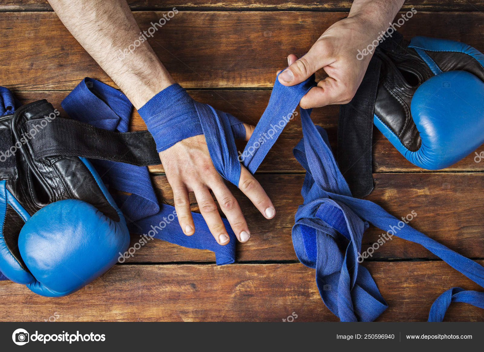 Man bandage boxing tape on his hands before the boxing match on a