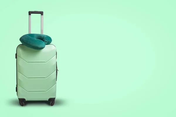 녹색 배경에 플라스틱 가방 및 여행 베개. 여행, 출장, 방문 친구와 친척에 게 여행의 개념 — 스톡 사진