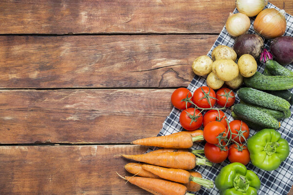 Fresh organic farm vegetables, Health care, on a wooden background. Harvest. Country style. Concept of a farm fair. Flat lay, top view. Copy space