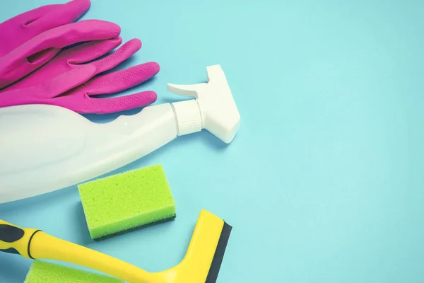 Cleaning and cleaning accessories, Gloves, spray, sponges, scraper for windows on a blue background. Cleaning Service Concept. Flat lay, Top view