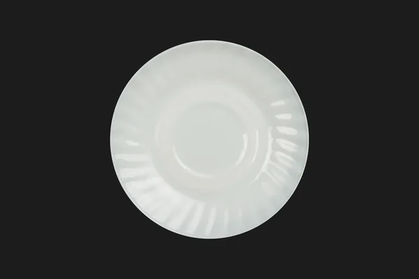 White saucer, plate on an isolated dark background. Flat lay, top view. — 스톡 사진