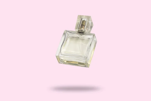 Perfume bottle on a pink background. The concept of a favorite fragrance, perfume for the beloved, Feramona. Levitation. Flat lay, top view. — Stock Photo, Image
