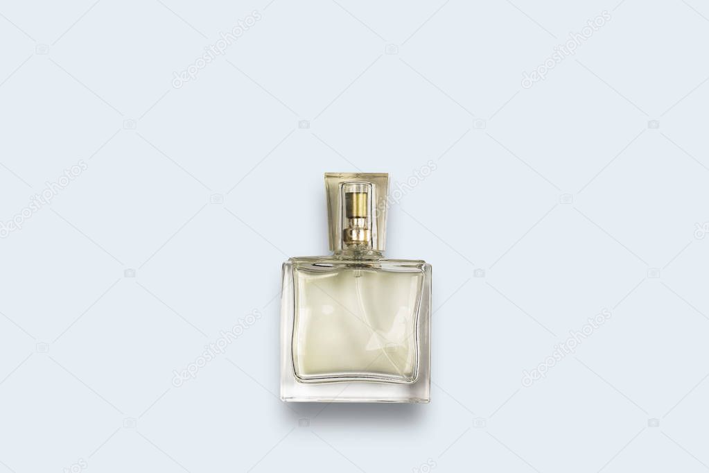 Perfume bottle on a blue background. Flat lay, top view.