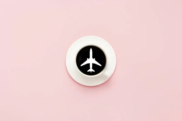 Weiße Tasse auf Untertasse, schwarzer Kaffee, rosa Hintergrund. Flugzeuge — Stockfoto