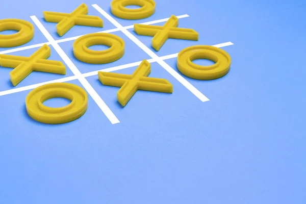 Yellow plastic crosses and a toe and a ruled field for playing t — Stock Photo, Image