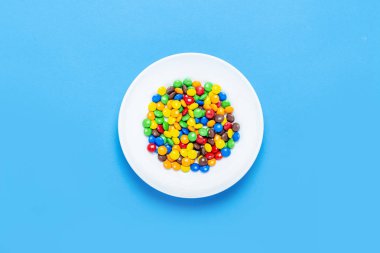 Renkli şekerler arka plan, kopya alanı. Çok renkli sır dragee fındık. Pasta dekorasyonu yayan tatlı şekerler. Renkli kaplı şeker yığını. Tatlılar doku, desen. Üst görünüm, düz yatıyordu