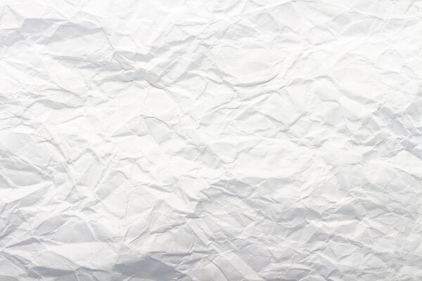 Crumpled white paper. Texture. Can be used as background or wallpaper. Flat lay, top view