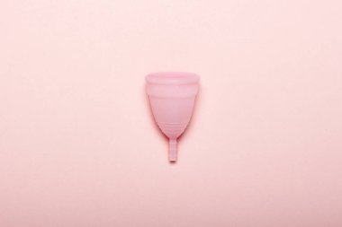 Pembe bir arka plan üzerinde adet fincan. Adet kavramı. Düz yatıyordu, üst