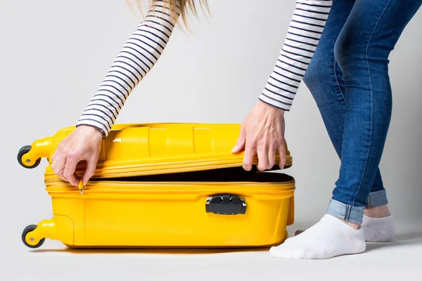 Young Woman Opens Suitcase Light Background Vacation Travel Concept — Stock Photo, Image