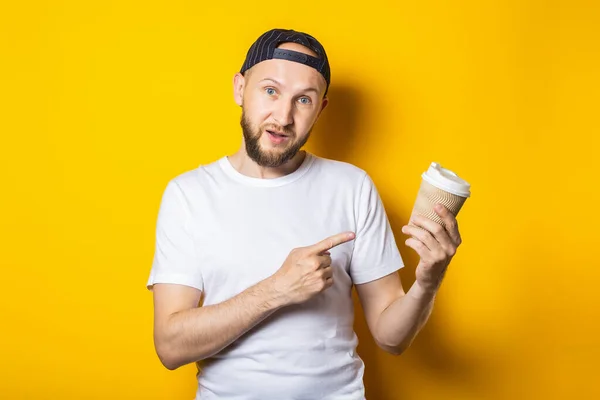 Friendly Smiling Young Man Points Finger Paper Cup Coffee Hand — Stock Photo, Image