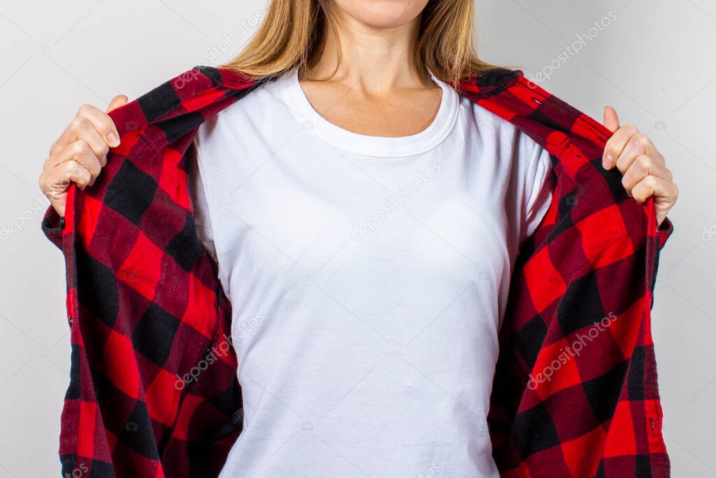 Young woman with a smile in a red shirt and white t-shirt on a white background. Concept template for text, logo, shock, surprise. Banner.