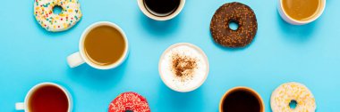 Tasty donuts and cups with hot drinks, coffee, cappuccino, tea on a blue background. Concept of sweets, bakery, pastries, coffee shop, meeting, friends, friendly team. Banner. Flat lay, top view. clipart