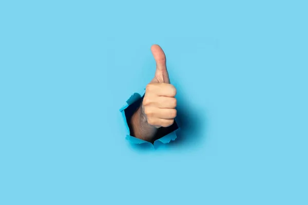 Male hand makes a hand up gesture on a blue background. Banner. Gesture all ok, like.