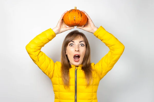 Young Girl Frightened Face Holds Pumpkin Her Head Light Background — Stock Photo, Image