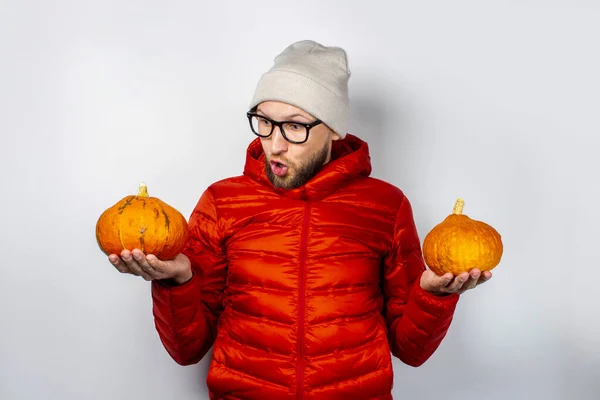 Scared Young Man Red Jacket Hat Holds Two Pumpkins Looks — Stock Photo, Image