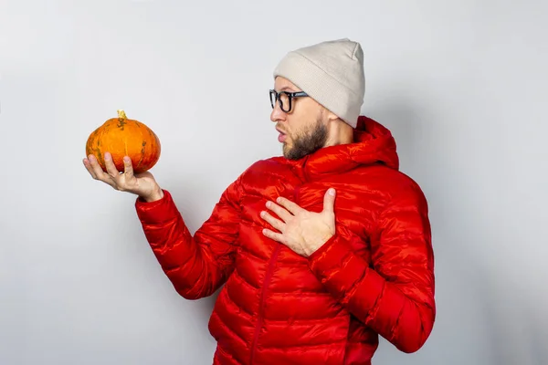 Shocked Young Man Red Jacket Hat Holds Pumpkin Holds His — Stock Photo, Image
