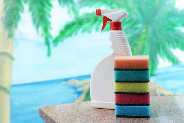 cleaning products for cleaning the house and mitting ware with a white bottle and sponges on a beautiful background