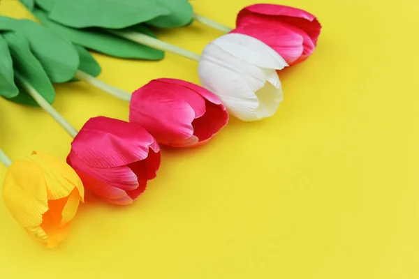 tulip flowers banner on a yellow background for the holiday