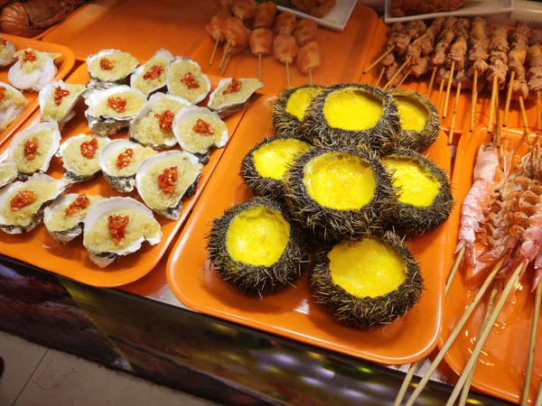 asian culture national sea food oysters and sea urchins squid on Hainan island China in Sanya city