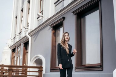 Şehrin arka planına karşı siyah takım elbiseli iş kızı.