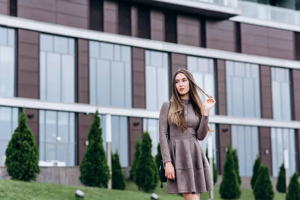 Mladá dívka kráčí poblíž kanceláře s kabelkou na rameni — Stock fotografie