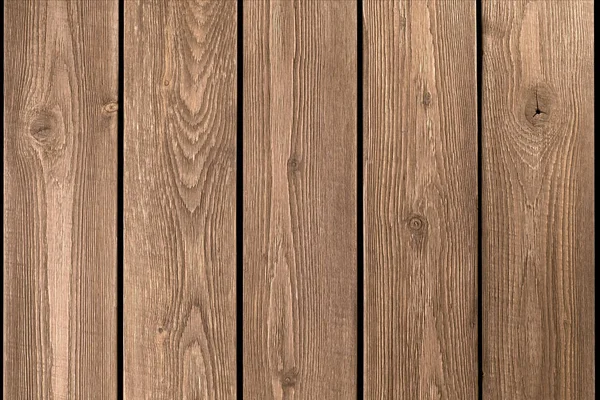 Overfladen af en gammel lurvet træ brun bord. Lodrette planker. Smuk moderne trendy træ tekstur baggrund - Stock-foto
