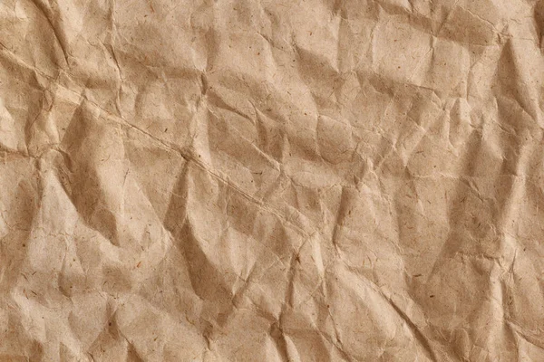 Crumpled rough brown creased wrapping paper. Abstract paper texture background with copy space.